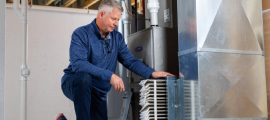 man inspecting furnace